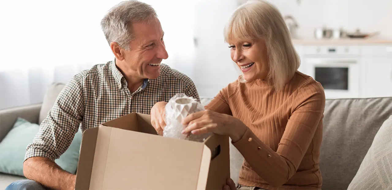 SurviveAndThrive-img 55+ active adult couple opening package